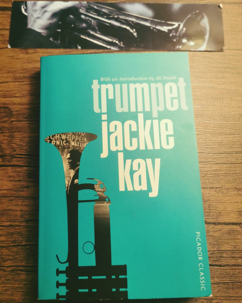 Photograph of a paperback copy of Trumper with a themed bookmark.